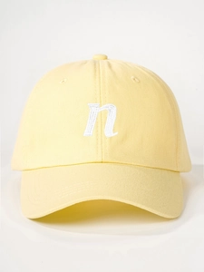 Detail of white letter N embroidery on light yellow cotton twill baseball cap