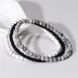 Detailed stack of 4mm natural amethyst, onyx, and turquoise beaded elastic bracelets