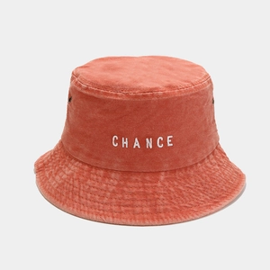 Detail of rust orange vintage cotton bucket hat with white CHANCE embroidery and air vents