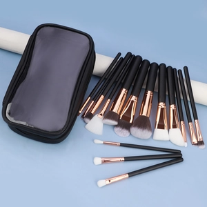 Close-up of professional makeup brush set with rose gold ferrules and black travel bag