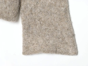 Close-up of oatmeal marled knit sweater showing soft mohair texture and ribbed cuff
