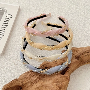 Detail of twisted woven headbands with pearl chains and crystals in pastel colors