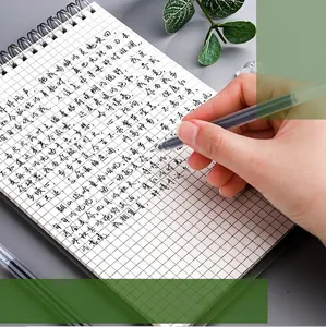 Black 0.5mm large capacity gel pen writing smoothly on a grid spiral notebook