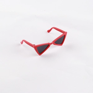 Detail view of red triangle frame cat-eye pet sunglasses with dark lenses for small dogs