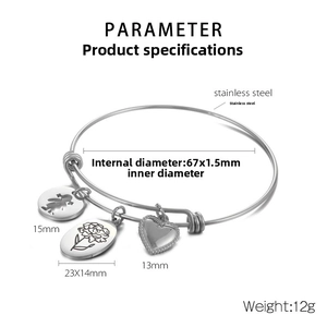 Detailed view of adjustable stainless steel bangle with flower and silhouette charms