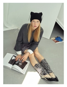 Detailed knit texture of the black cat ear beanie with ribbon bows and openwork pattern