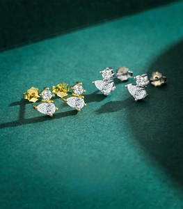 Macro shot of 925 sterling silver stud earrings with round and pear-cut cubic zirconia