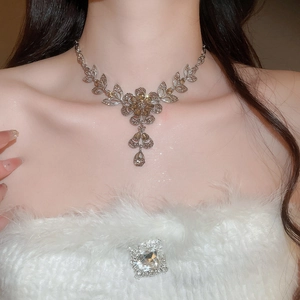 Elegant floral necklace detail with champagne crystals and silver-tone leaf design