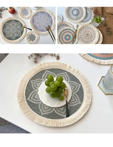 Detail of round cotton linen placemat with bohemian mandala pattern and tassel fringe