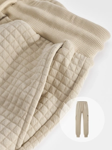Detail of light khaki waffle knit texture and drawstring waistband on men's jogger pants