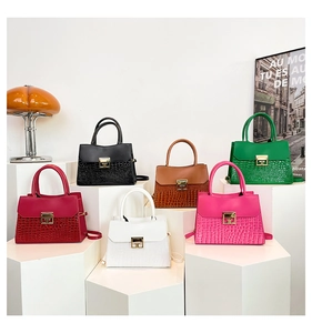 Selection of vibrant crossbody bags with crocodile texture and gold hardware on display