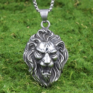 Polished stainless steel lion head pendant with box chain on green moss background