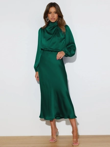 Detail of elegant dark green satin maxi dress with a sleek high neck and flowing silhouette