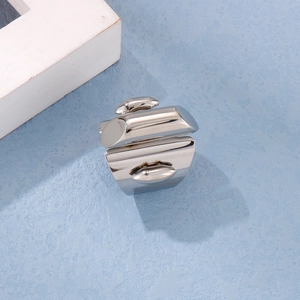Detailed view of irregular geometric silver titanium ring with a polished metallic finish