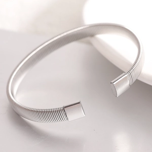 Minimalist 6mm stainless steel elastic open bangle with a polished silver spring design