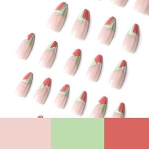 Orange and green geometric press-on nails set with long stiletto shape on white background