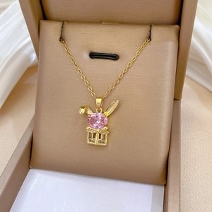 Detail of bunny pendant necklace with pink crystal and hollow gift box design
