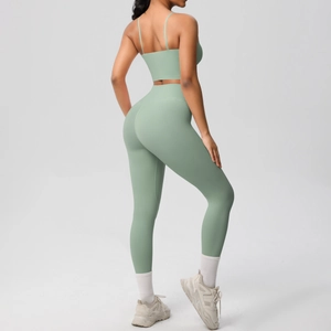 Sage green yoga set detail showing cross back bra and high-waisted lifting leggings