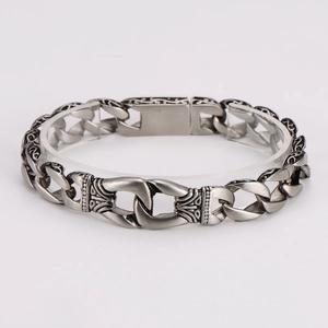 Macro shot of retro silver engraved links on a vintage style metal chain bracelet