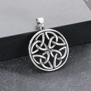 Macro detail of silver Celtic Quaternary Knot pendant on a textured display box