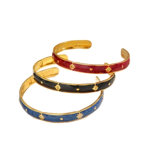 Three gold-plated enamel star bangles in red, black, and blue with zircon accents