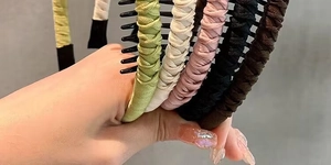 Close-up of fabric-wrapped non-slip headbands in five colors with internal comb teeth