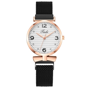 Women's quartz watch with rose gold case, diamond dial, and black Milanese magnetic strap