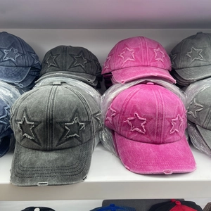 Vintage distressed baseball caps with star patch in multiple colors on a shelf display