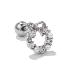 Macro detail of silver bow wreath earrings with white pearls and sparkling cubic zirconia