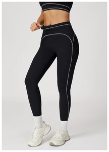 Detail of high-waisted yoga pants with white contrast stitching and fold-over waistband