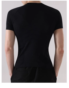 Macro shot of breathable knit texture on back of men's slim fit black sports t-shirt