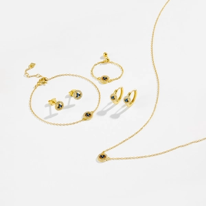 Elegant gold S925 sterling silver jewelry set featuring blue stones on a clean white background