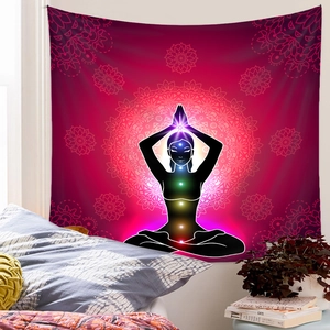Detailed shot of a pink meditation tapestry with chakras and mandala on a bedroom wall