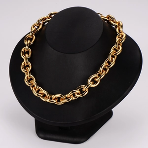 Bold golden chunky chain necklace displayed on a black matte bust mannequin stand