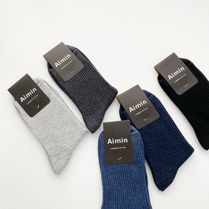 Five pairs of men's combed cotton crew socks in neutral colors with ribbed texture