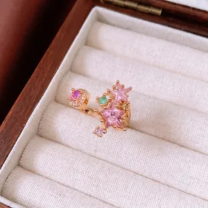 Exquisite gold star open ring with pink zircon and moon stones in a jewelry box