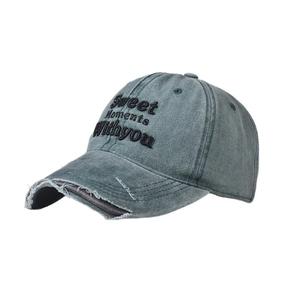Detail of vintage washed gray baseball cap showing distressed brim and letter embroidery