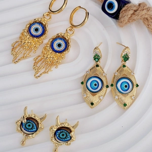 Vintage gold plated evil eye earrings set with blue enamel and sparkling rhinestones