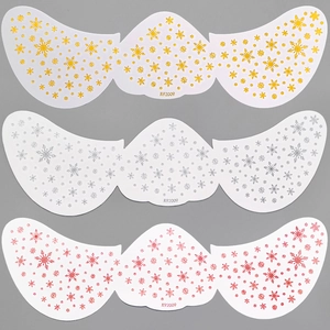 Detailed view of snowflake face stickers in gold, silver, and pink metallic finishes