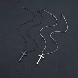 Detail view of black and silver stainless steel cross pendants with rounded link chains