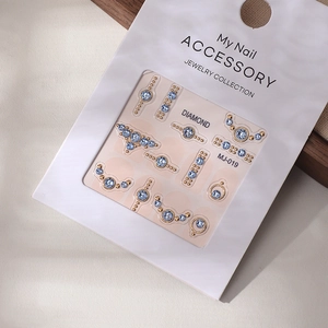 Detailed view of light blue K9 crystals and gold beads nail art set on MJ-019 model card