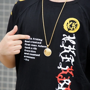 Iced out Eye of Horus medallion pendant on model with 18K gold plated finish