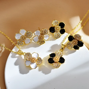 Elegant gold-plated flower jewelry set with black and white petals and zircon inlays