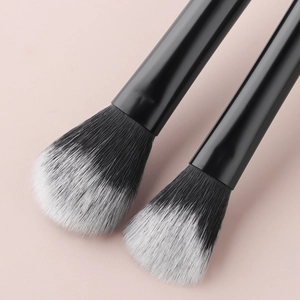 Macro shot of black and white gradient bristles on professional makeup brushes set