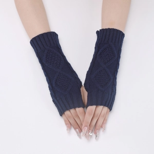 Detail of dark blue knit fingerless gloves with diamond pattern on a white background
