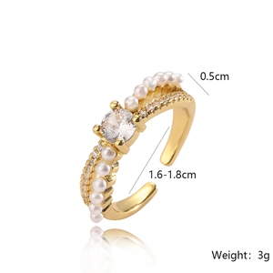 Detail view of gold adjustable ring showing pearl and zircon settings with 0.5cm width
