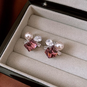 Detail of silver earring with purple square stone, teardrop zircon and white pearl