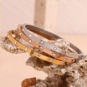 Detailed shot of gold and silver plated bangles with inset cubic zirconia stones