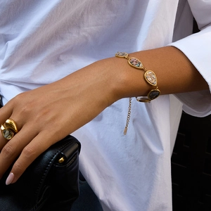 Detail of 18K gold stainless steel jewelry set with teardrop abalone shell inlay