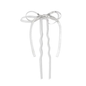 Detailed view of silver bow-shaped hair clip with textured metallic surface and dual prongs